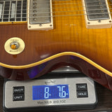 Guitar on a digital scale displaying weight