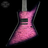 A modern electric guitar with a distinctive angular body, featuring a vibrant magenta and purple flamed maple top with a black finish. The neck is dark wood, and the guitar is photographed against a solid black background with a Tone Shop watermark in the upper left corner.