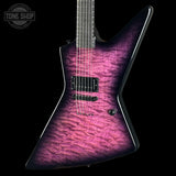 A custom electric guitar with a vibrant purple and pink flamed maple top, shown against a solid black background with a Tone Shop watermark in the upper left corner.