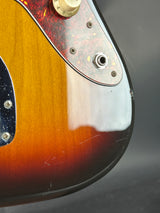 Close-up of a guitar's control panel with a gradient finish.