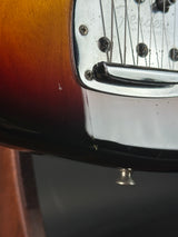 Close-up of a guitar's headstock and tuning pegs.