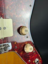 Close-up of a guitar with control knobs and bridge