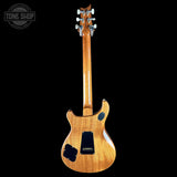 The back view of a Gibson electric guitar with a natural wood finish, shown against a solid black background with a Tone Shop watermark in the top-left corner.