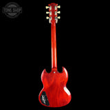 Red electric guitar on a black background with 'Tone Shop' logo.