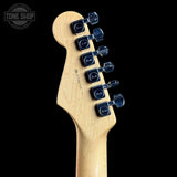 Guitar headstock with tuning pegs on a black background, featuring the Tone Shop logo.