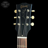 Gibson Les Paul guitar headstock with brand logo on a black background