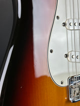 Close-up of a guitar's neck and headstock with a sunburst finish.