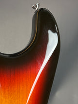 Close-up of a guitar's neck and headstock with a gradient finish.