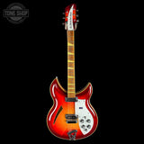 Electric guitar with a red and white design on a black background, featuring the Tone Shop logo.
