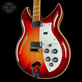 Glossy electric guitar with a two-tone finish on a black background, featuring 'Tone Shop' branding.