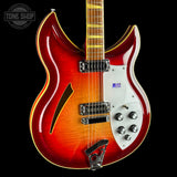Electric guitar with a red and white design on a black background, featuring the Tone Shop logo.