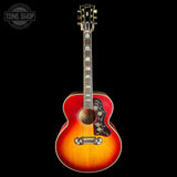 Acoustic guitar with a sunburst finish on a black background, featuring the Tone Shop logo.