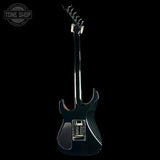 Black electric guitar on a white background with 'Tone Shop' logo.