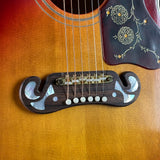 Close-up of an acoustic guitar's soundhole and bridge