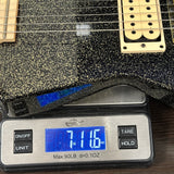 Guitar on a digital scale displaying weight