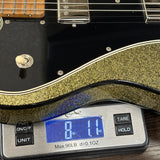 Used Gregg Deluxe T-Style Gold Sparkle on scale displaying weight.