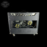 Guitar amplifier with visible components on a black background, featuring 'Tone Shop' logo.