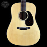 Acoustic guitar with a visible brand logo on a black background