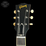 Gibson guitar headstock with brand logo on a black background