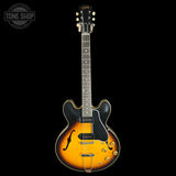 Gibson electric guitar with a sunburst finish on a black background
