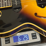 Guitar on a digital scale displaying weight