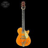 Electric guitar with a sunburst finish on a black background, featuring the Gretsch logo.