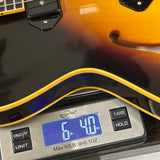 Guitar on a digital scale displaying weight