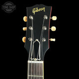 Gibson guitar headstock with brand logo on a black background