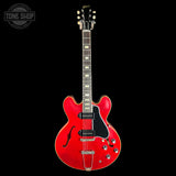 Red electric guitar on a black background with 'Tone Shop' logo.