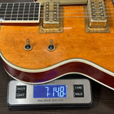 Electric guitar on a digital scale showing weight