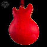 Red electric guitar body on a black background with 'Tone Shop' logo.