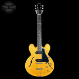 Yellow electric guitar on a black background with 'Tone Shop' logo.