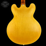 Back view of a guitar with a visible 'Tone Shop' logo.