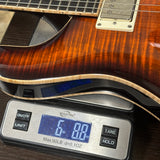 Used 2024 PRS SE Hollowbody Piezo Sunburst on scale displaying weight.