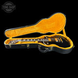Guitar in an open case with a black background and 'Tone Shop' logo.
