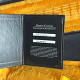 Gibson Custom Certificate of Authenticity on a yellow textured surface