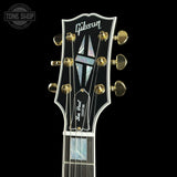 Gibson guitar headstock with brand logo on a black background