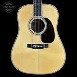 Acoustic guitar with a visible brand logo in the corner