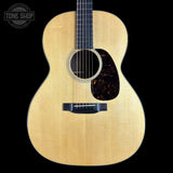 Acoustic guitar with a visible brand logo in the corner