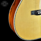 Close-up of a guitar with a visible brand logo in the corner.