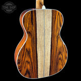 Close-up of a guitar's back with a visible brand logo in the corner.