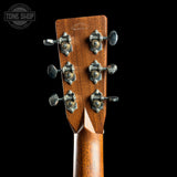 Close-up of the headstock of a Martin D-21 acoustic guitar, showing six tuning pegs and the brand name 'MARTIN D-21' on a black background.