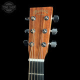 Close-up of the headstock of a Martin D-21 acoustic guitar against a solid black background, showing the wood grain, six tuning pegs, and strings. A Tone Shop watermark is visible in the top left corner.