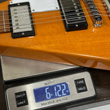 Electric guitar on a digital scale displaying weight