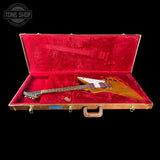 Guitar in a red-lined case with 'Tone Shop' logo.