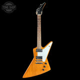 Electric guitar with a wooden body and white pickguard on a black background, featuring 'Tone Shop' branding.