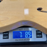 Digital scale displaying weight on a wooden surface