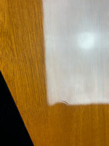 Close-up of a wooden surface with a white and gold patterned overlay