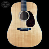 Acoustic guitar with a visible brand logo in the corner