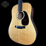 Acoustic guitar with a visible brand logo in the corner
